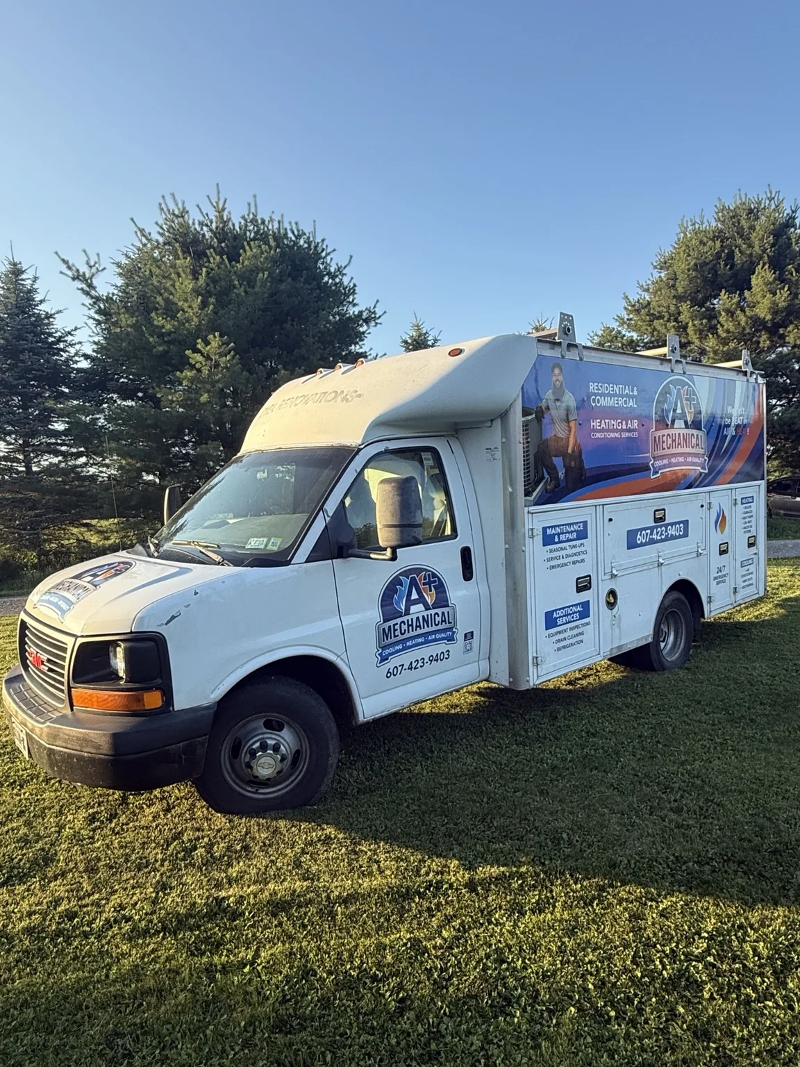 Branded A+ Mechanical service truck with blue and orange side graphics