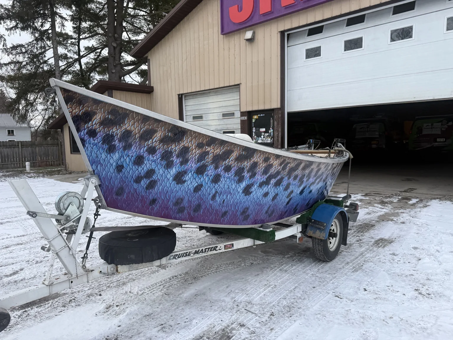 Another angle showing the large custom fish-scale graphics on the boat
