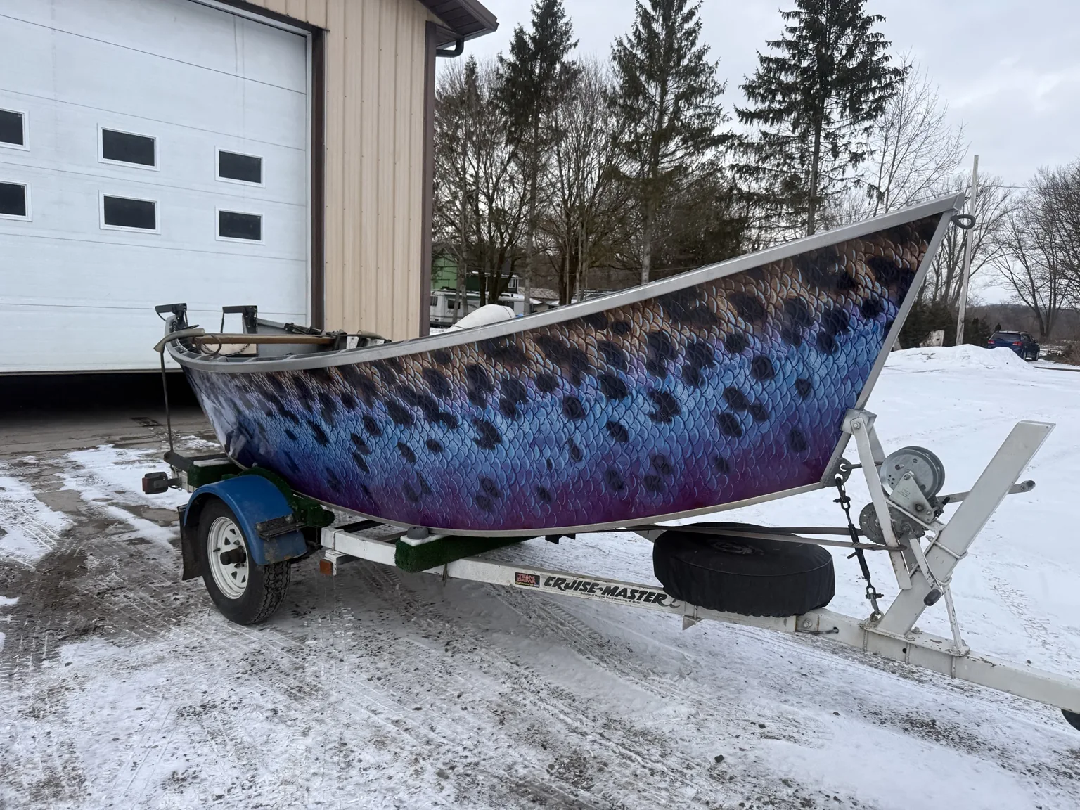 Colorful blue-purple fish-scale vinyl graphics on a boat